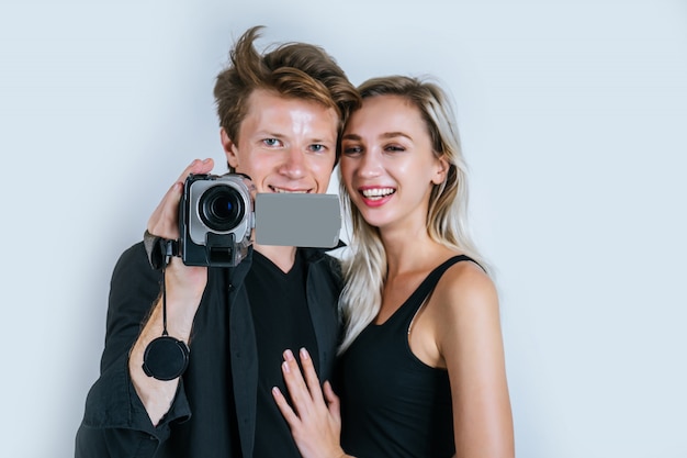 Free photo happy portrait of couple holding video camera and record clip video