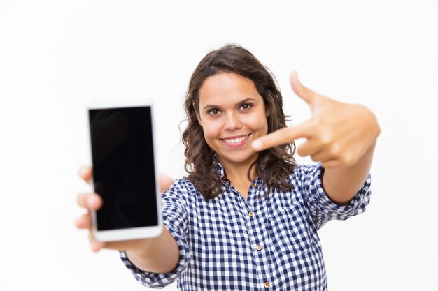 Happy positive customer pointing finger at blank phone screen