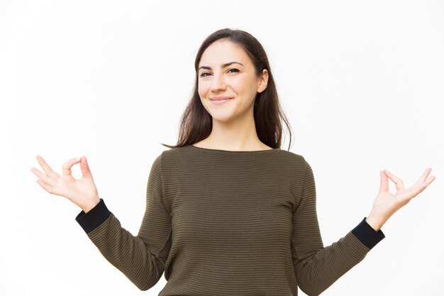 Happy positive female woman making zen gesture