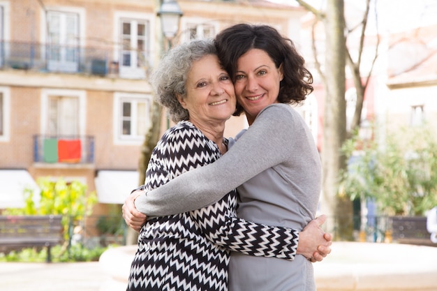 Happy positive young woman posing with her mom