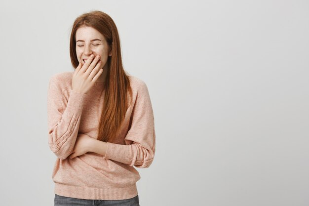 Happy pretty redhead woman laughing