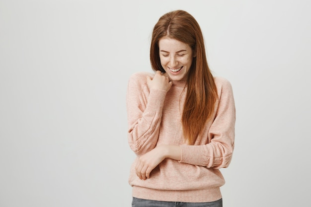 Happy pretty redhead woman laughing