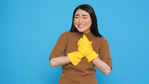 Happy professional maid being happy about finishing home cleaning while enjoying appreciation from her clients. Homekepper doing wonderful job, making sure every inch of the house was spotless.