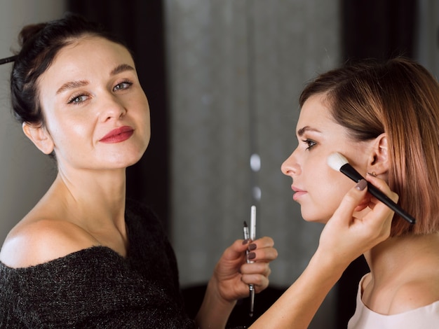 Happy professional make-up artist working