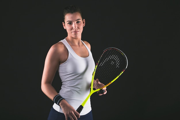 Free photo happy professional player posing with her squash racket