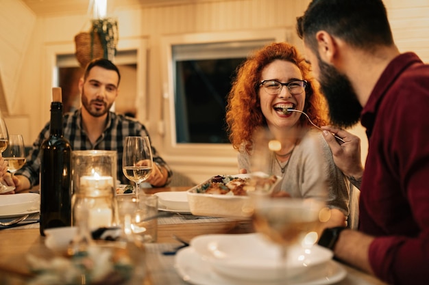 Free photo happy redhead woman having fun while being fed by her boyfriend during a meal in dining room