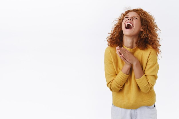 happy redhead woman with curly hair, laughing out loud on white