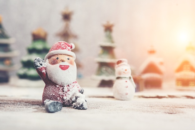 Free Photo happy santa claus with snowman background