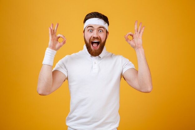 Happy screaming sportsman showing ok signs