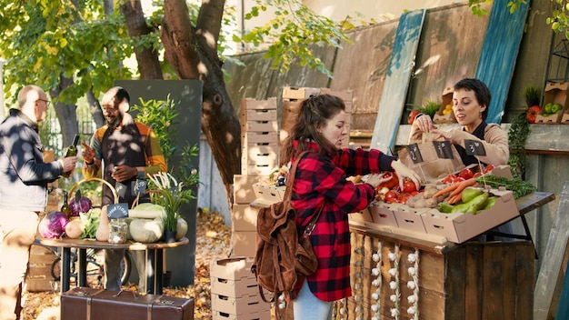 Free Photo happy seller talking to client and selling seasonal locally grown veggies