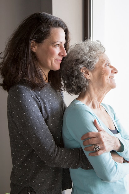 Free photo happy senior lady feeling love of her adult daughter