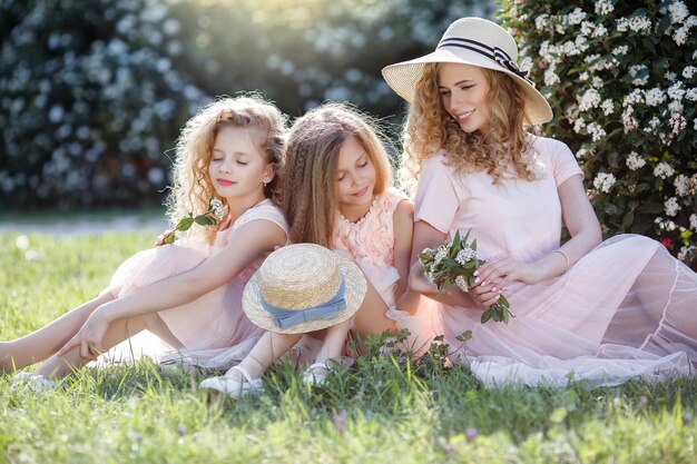 happy sisters portrait outdoor on grass