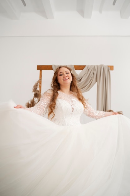 Free Photo happy and smiley bride posing in wedding dress