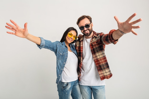 Happy smiling couple holding hands in camera isolated on white studio