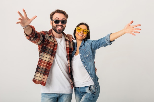 Happy smiling couple holding hands in camera isolated on white studio