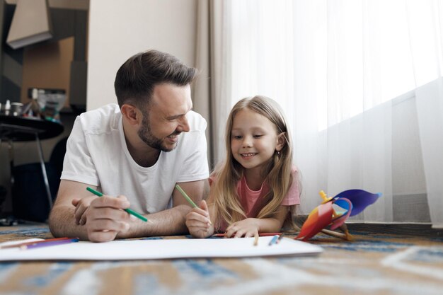 happy smiling father and his daughter at home