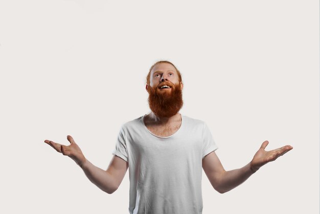 Happy and smiling man in white t-shirt wins the prize and opens his arms