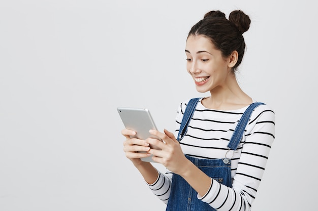 Happy smiling woman looking at digital tablet display