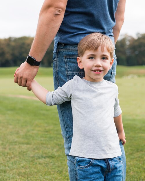 Happy son holding his father's hand front view