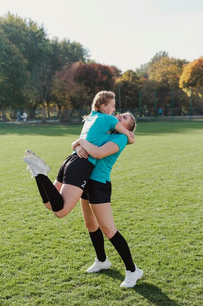 Happy sportive girls embracing each other