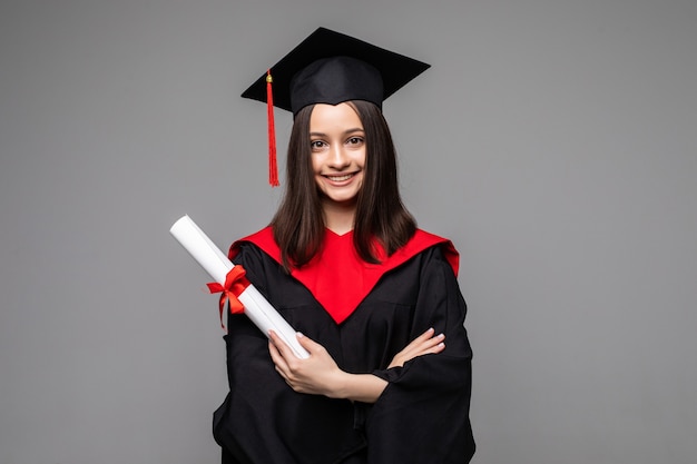 Free photo happy student with graduation hat and diploma on grey