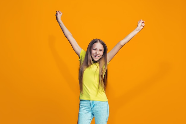 Free photo happy success teen girl celebrating being a winner. dynamic energetic image of female model