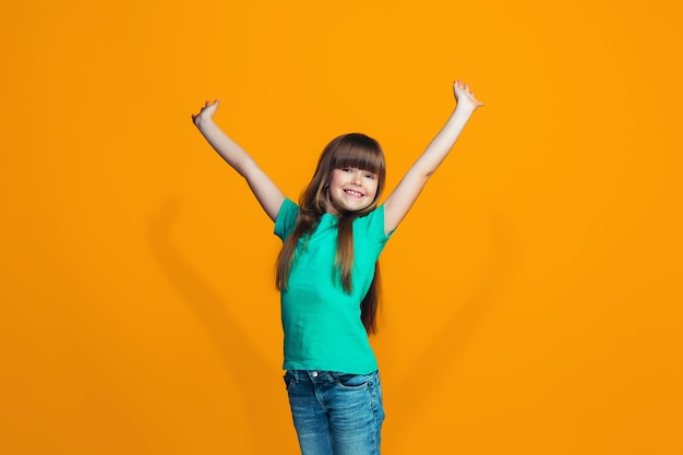 Free photo happy success teen girl celebrating being a winner. dynamic energetic image of female model