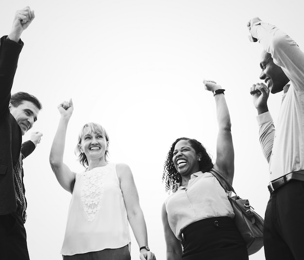 Free photo happy successful business people raining their arms