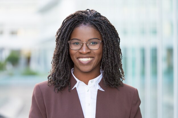 Happy successful business professional posing outside