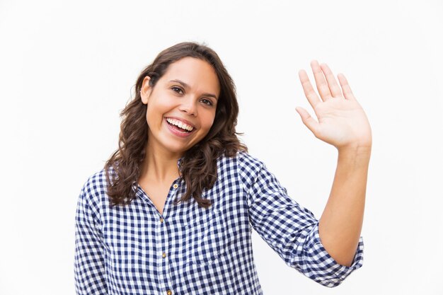 Happy sweet woman waving hello