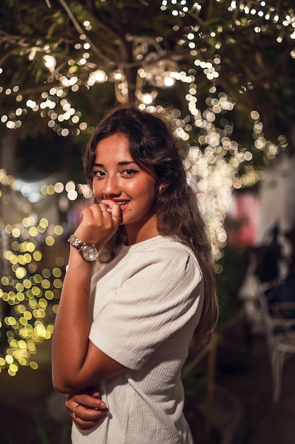 Happy tanned Caucasian female at an amusement park