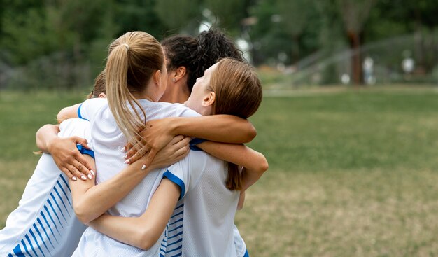 Happy team hugging on field