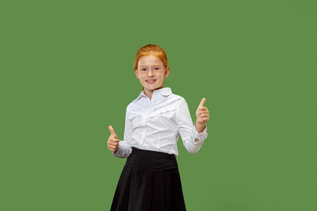 Free photo happy teen girl standing and smiling against on green