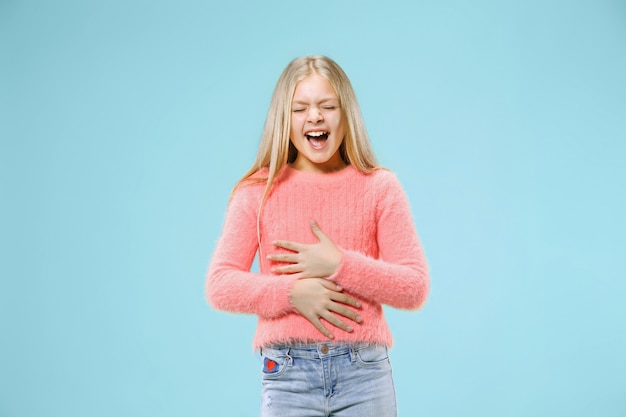 Free Photo happy teen girl standing, smiling isolated on trendy blue studio background. beautiful female portrait.