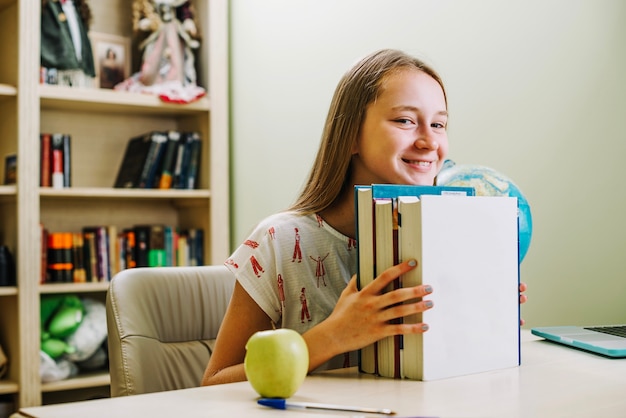 Happy teen girl with books