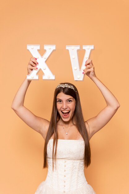 Happy teenager holding roman numerals