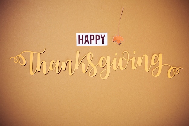 Happy Thanksgiving lettering on brown background