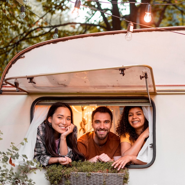 Free photo happy three friends ready to go on a road trip