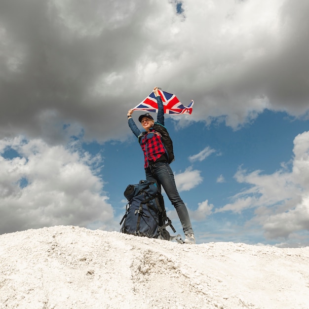 Free photo happy traveler with a flag outdoor