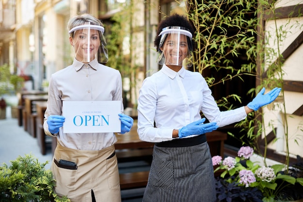 Free photo happy waitresses reopening cafe after coronavirus quarantine