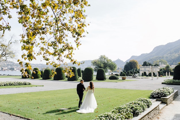 Free photo happy wedding couple in como lake, italy