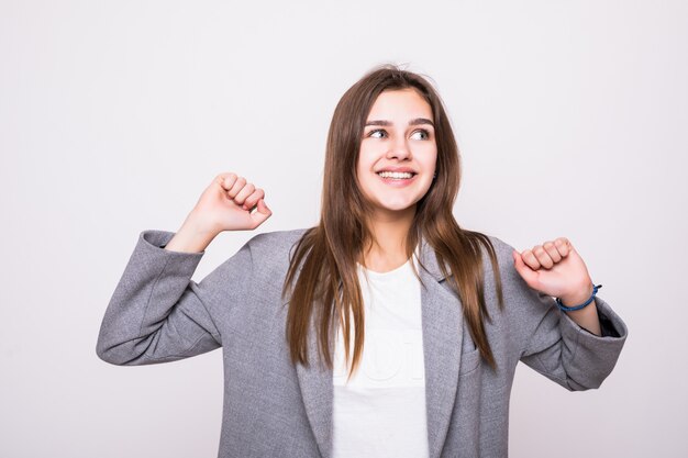 Happy winner. Success business woman celebrating screaming and dancing of joy winning on white background