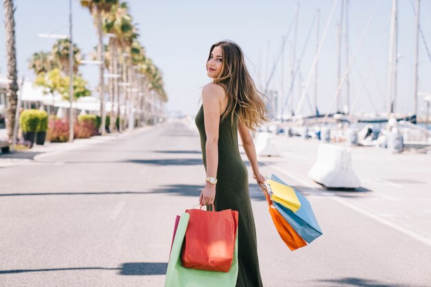 Happy woman after shopping under the sun