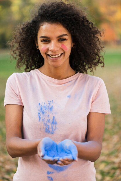 Happy woman celebrating holi with color