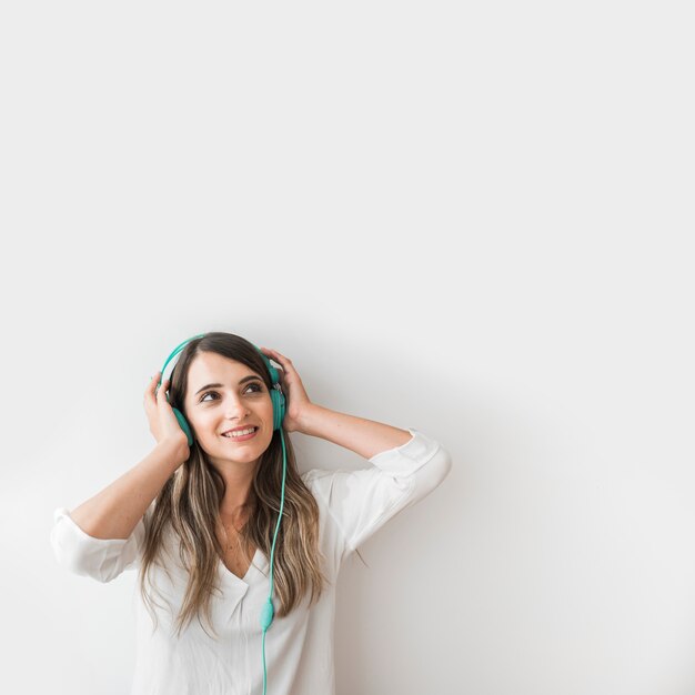 Happy woman dancing with earphones