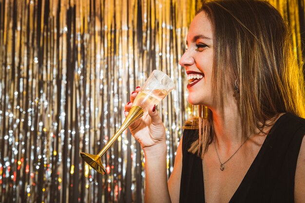 Happy woman drinking champagne at new year celebrations