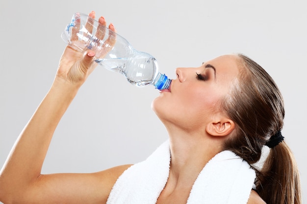 Happy woman drinking water