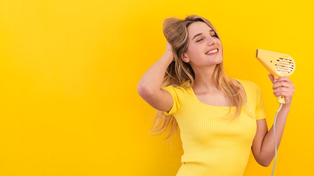 Happy woman drying her hair