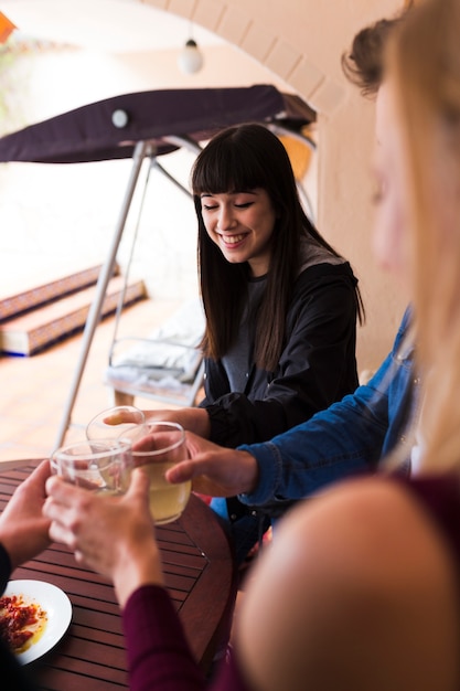 Happy woman enjoying alcohol with her friends