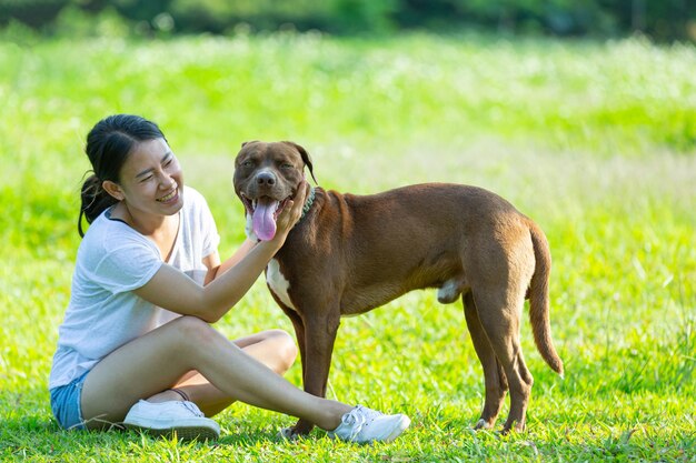 Happy woman enjoying her favorite dog in the park.